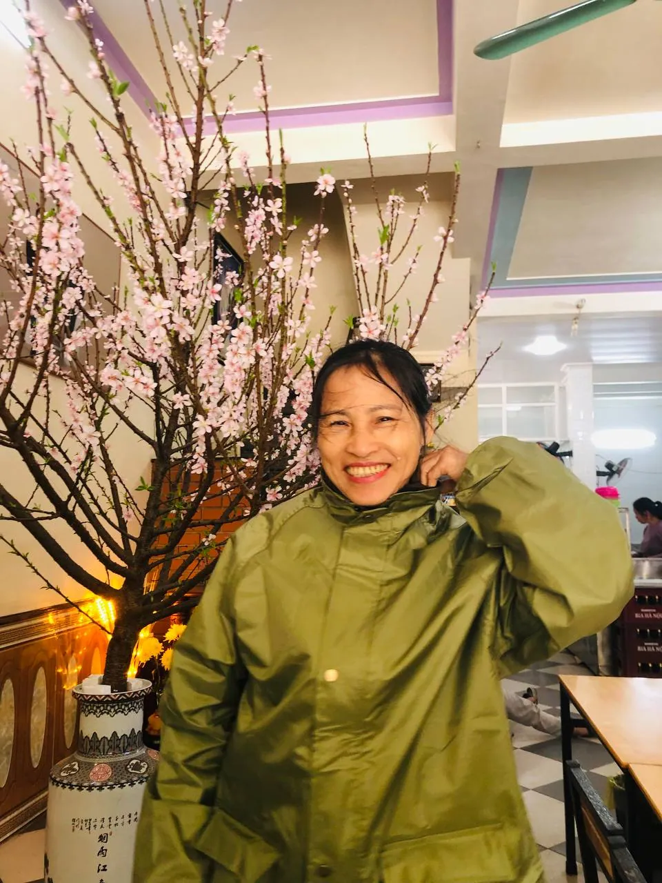 Áo khoác olive trước cành đào nở